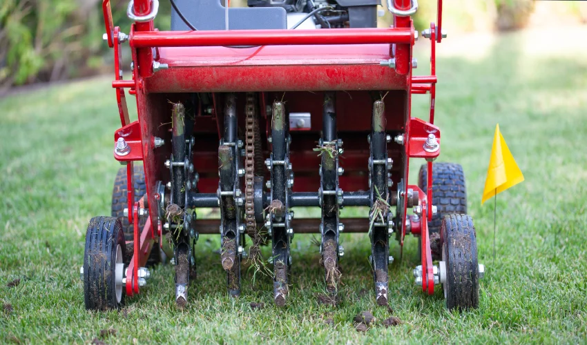 Core aerator removing plugs from a lawn